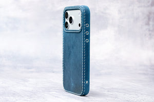 Ravenweave Cobalt leather iPhone case in hand, landscape view