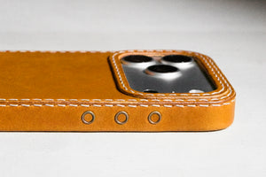 Ravenweave Honey leather iPhone case showing action button side