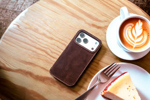 Ravenweave Walnut leather iPhone case lifestyle, dark brown patina