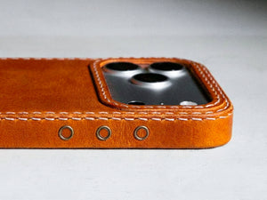 Ember oil-waxed leather iPhone case, Ravenweave studio flat lay