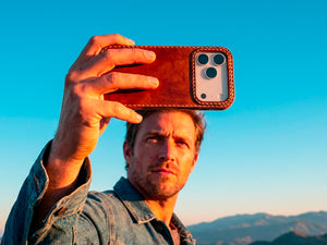 Ravenweave Ember leather iPhone case in outdoor setting